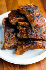 Pork BBQ Ribs. Tradtional Classic barbecue staple. Pork ribs seasoned with a dry rub and slow cooked in a smoker over mesquite wood chips and covered in bbq sauce. 