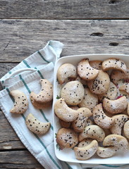 Homemade shortbread cookies sprinkled with sugar with black sesame seeds on a wooden rustic table. Place for text. Photo for the holiday, Shrovetide, Christmas, New Year, Easter.