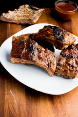 Pork BBQ Ribs. Tradtional Classic barbecue staple. Pork ribs seasoned with a dry rub and slow cooked in a smoker over mesquite wood chips and covered in bbq sauce. 