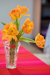 A bouquet of tulips in a vase on the table.