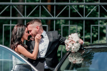 close up. bride and groom standing near the car