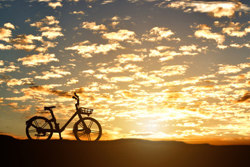 Fototapeta na wymiar Silhouette of a bicycle against sunset background.