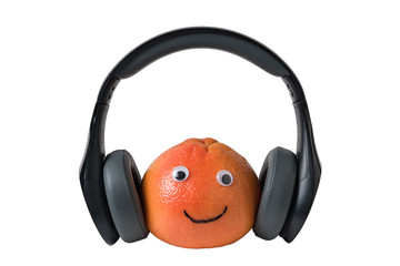 Orange smiley with headphones on an isolated white background. .. Food with Funny Faces.