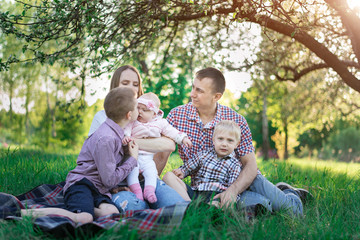 Fototapeta premium Young family with children spends their free time together. Concept candid happy family
