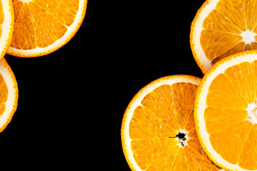 Fresh orange slices on a black background.