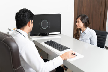 Fototapeta na wymiar Doctor Discussing With Patient Over Brain Ct Scan