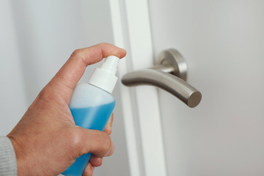 Man Disinfecting The Door Handle