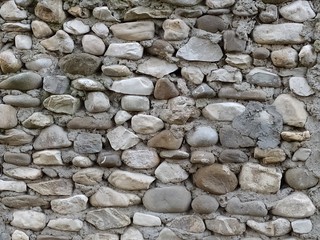Background of stones. Old stone medieval wall background. Masonry walls in medieval Italian style. Close-up.