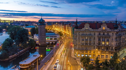 Sitkovska water-tower timelapse circa 1588 and traffic on road in old city center of Prague day to night.