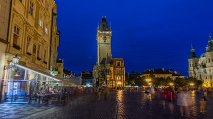 Fototapeta na wymiar Prague Old Town Hall at Night timelapse with unrecognizable tourists walking