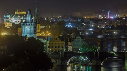 Fototapeta na wymiar Scenic view of bridges on the Vltava river night timelapse and of the historical center of Prague: buildings