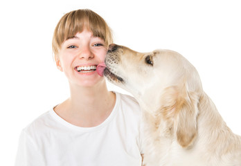 Nice teen woman and her beautiful Golden Retriever dog over white background