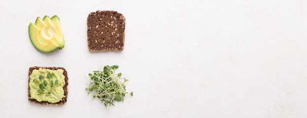 Vegetarian sandwich components. Rye bread, avocado and microgreen