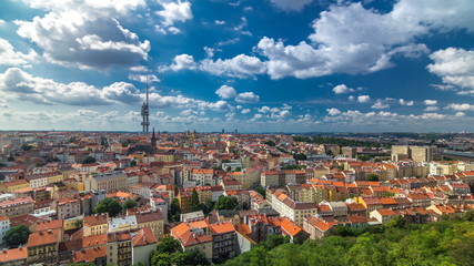 Fototapeta na wymiar Timelapse view from the top of the Vitkov Memorial on the Prague landscape on a sunny day with the famous Zizkov TV tower on the horizon