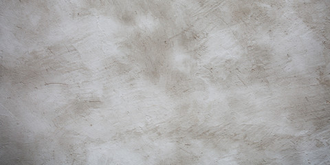 White concrete wall as background with clouds of brown colors