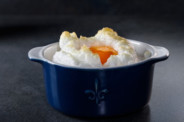 Delicate baked egg Orsini (eggs in the cloud). French breakfast.