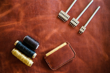 Leather card wallet handmade with thread and leather tool object