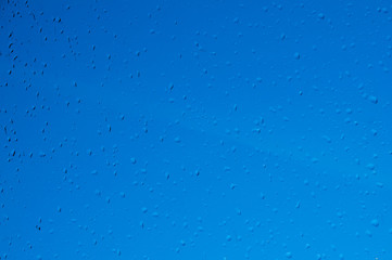 Drops of water on the glass. Rain. Blue background