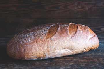 Rye bread. Homemade baking. On a wooden background.