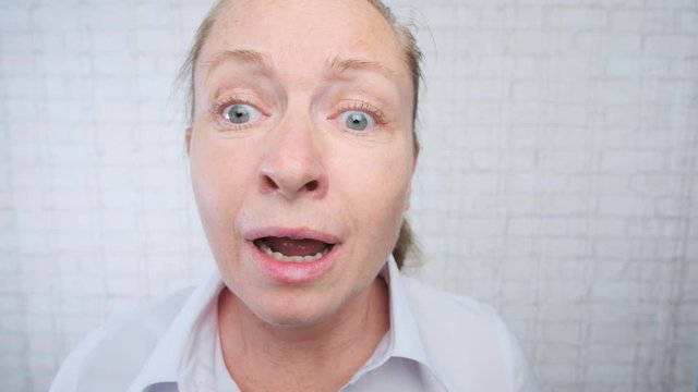 Portrait of adult crying woman making excuses in office on light background.
