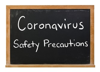 Obraz premium Coronavirus Safety Precautions written in white chalk on a black chalkboard isolated on white