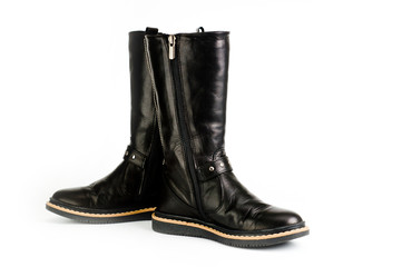 Black leather women?s boots fastened with a zipper. Background for shoes.