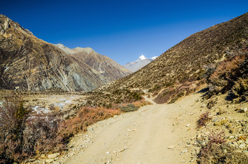 Trekking route from Manang village to Torung La in autumn sunny day. Annapurna circuit trek, Nepal.
