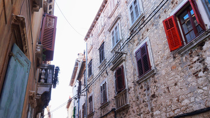Street with beautiful old buildings of different colours in Rovinj, Croatia