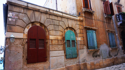 Fototapeta na wymiar Street with beautiful old buildings of different colours in Rovinj, Croatia
