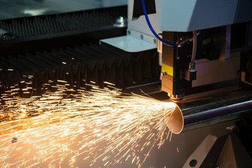 The fiber laser cutting machine cutting the stainless steel tube control by CNC program. The sheet...