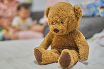 brown teddy bear in children bedroom.