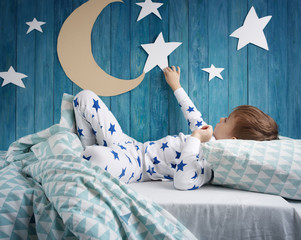 Five years old child sleeping in bed