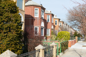 Row of Beautiful Old Brick Homes in Astoria Queens New York along the Sidewalk