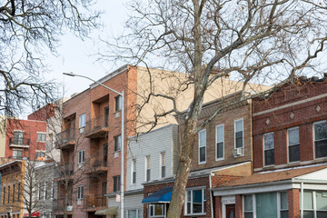 Row of a Variety of Old and New Brick and Wood Residential Buildings in Astoria Queens New York