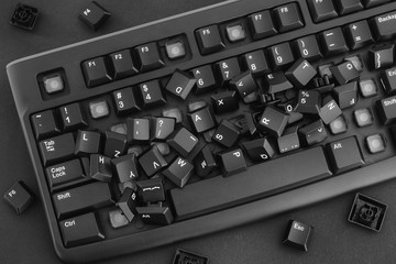 Heap of removed keys from a keyboard laying on the keyboard