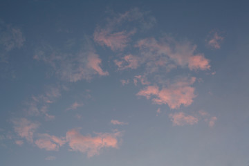Pink clouds in pale sky