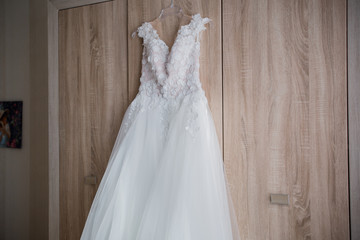 wedding dress hanging on the closet