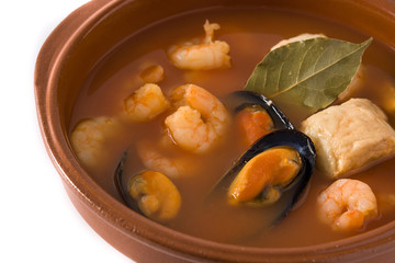 French bouillabaisse soup in bowl isolated on white background. Close up