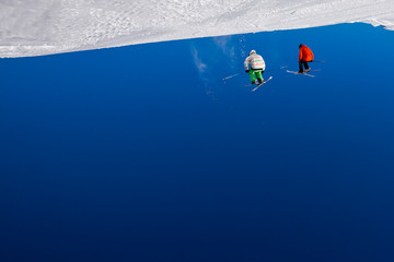 Abstract ski background with skiers in mid air, upside down.
