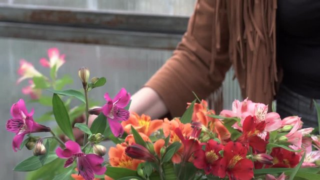women's hands in a flower shop process flowers, cut off the roots of flowers and stems