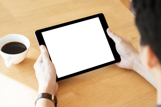 Mockup image of a man holding black color tablet device in hands