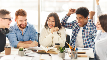 Enthusiastic students finished preparing their project and raise hands