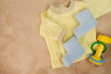 Infant baby boy clothes. Baby goods on textile background.