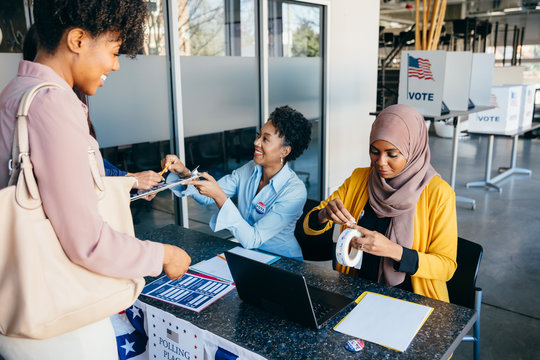 Volunteer helping citizen at polling place