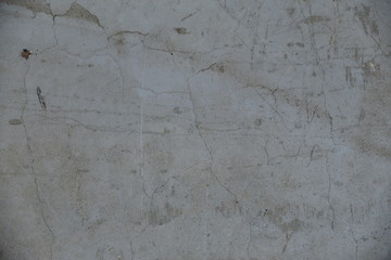 Cement wall with cracks in industrial building, surface for your design and texture background.
