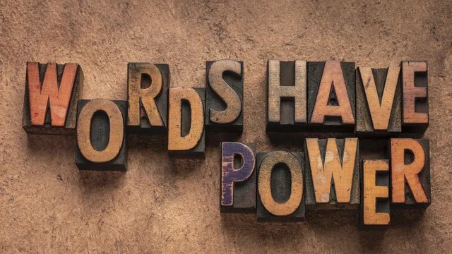 Words have power, communication concept - stop motion animation with vintage letterpress wood type printing blocks against textured handmade paper.