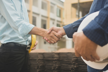 Contractor shake hand agreement success work at estate building construction site