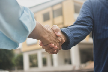 Contractor shake hand agreement success work at estate building construction site