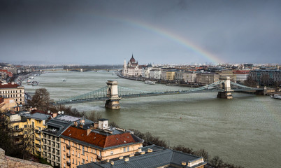 Chain Bridge over Danube in Budapest with Hungarian Parliament and a rainbow in Budapest