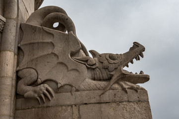 stone dragon statue on Buda Castle Hill a rainy winter day